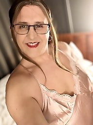 A woman wears a pink satin nightgown.